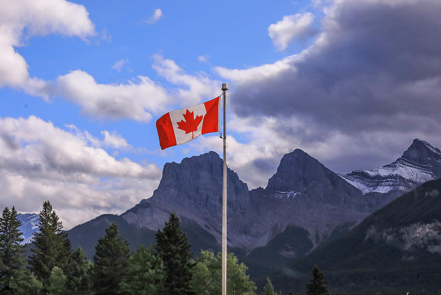 Canadian Rockies And Flag Of Canada Photograph by Dan Sproul