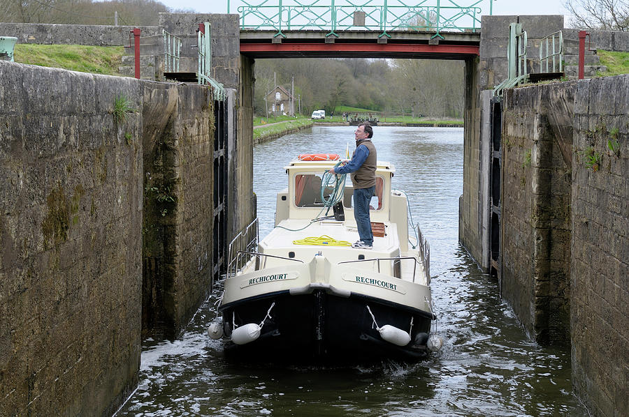 Canal boat entering the lock in Saint-Didier, Ecluse 36 Laporte, Les Rompees, Saint-Didier, Nievre, Burgundy, France Photograph by Kevin Oke