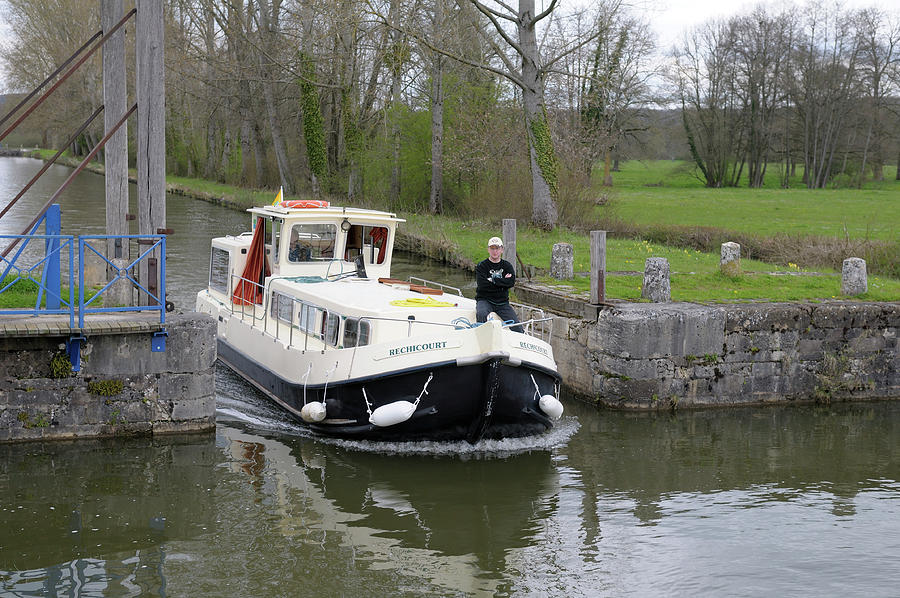 Canal boat passing through Pont Levis de Dirol, Le Bourg, Dirol, Nievre, Burgundy, France Photograph by Kevin Oke