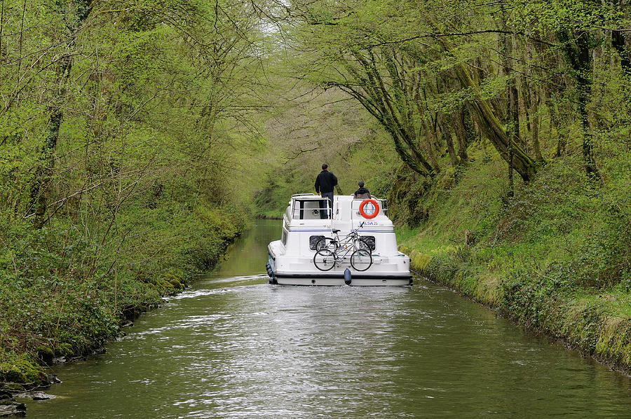 Canal boat under a canopy of trees, Nivernais Canal, La Collancelle, Nievre, Burgundy, France Photograph by Kevin Oke