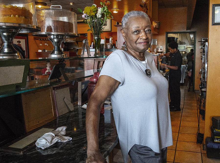 Candid portrait of the active Senior Black businesswoman in her small local restaurant Photograph by Alex Potemkin
