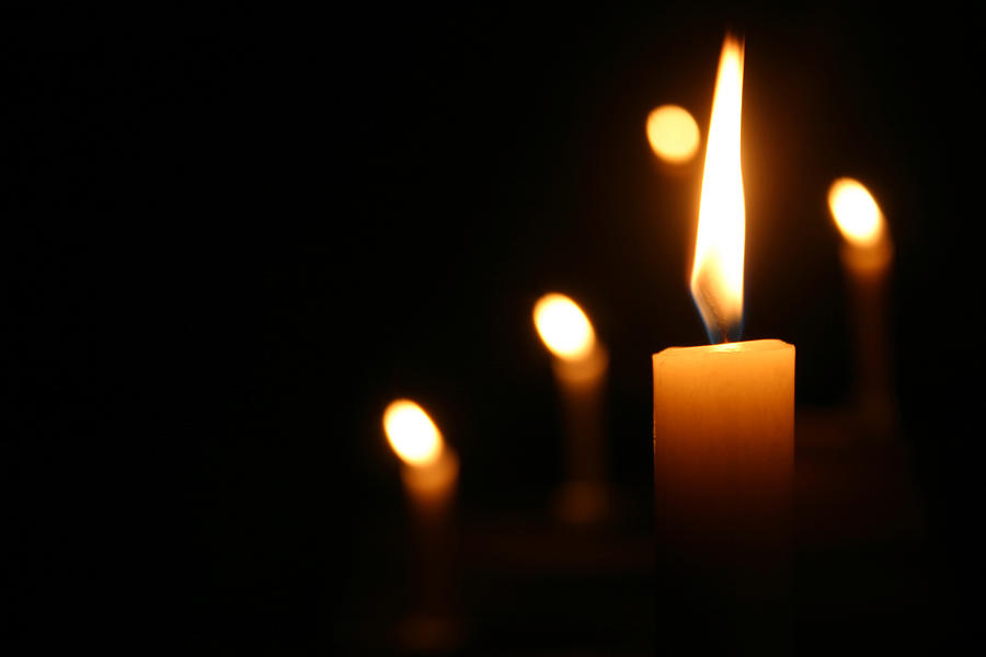 Candles Burning in Dark Church Photograph by Stocknshares