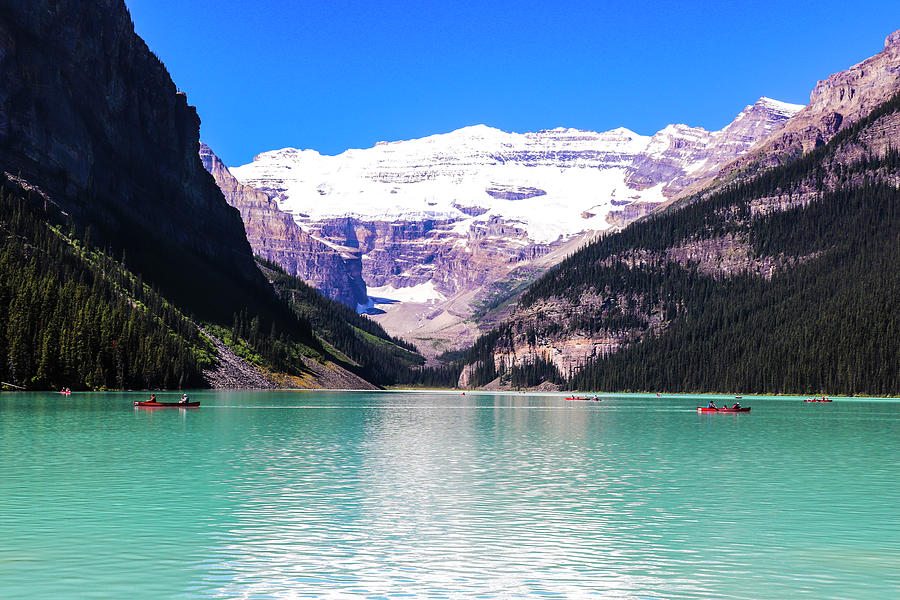 Canoe on Lake Louise in the middle of the mountains Photograph by Ndy ...