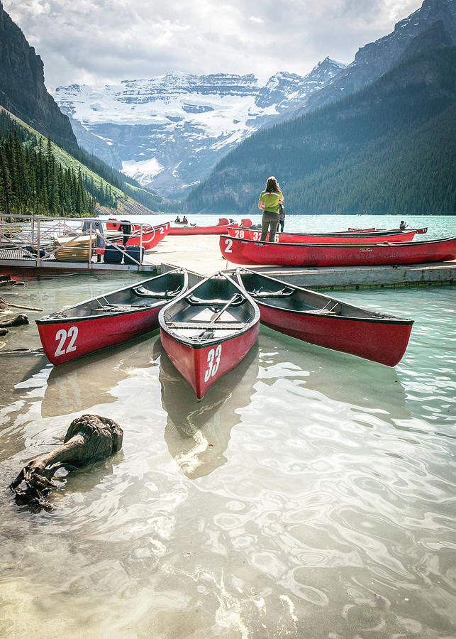 Canoes floating on beautiful Lake Louise in Banff National Park, Canada Photograph by Peter Kolejak