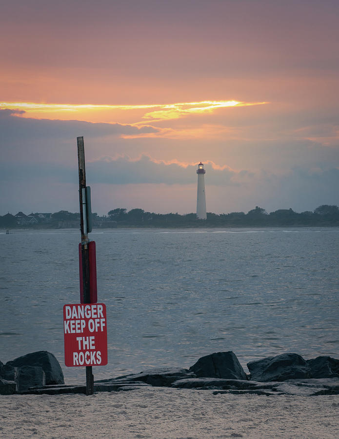 Cape May Beach Lighthouse and Danger Sign Photograph by Jason Fink