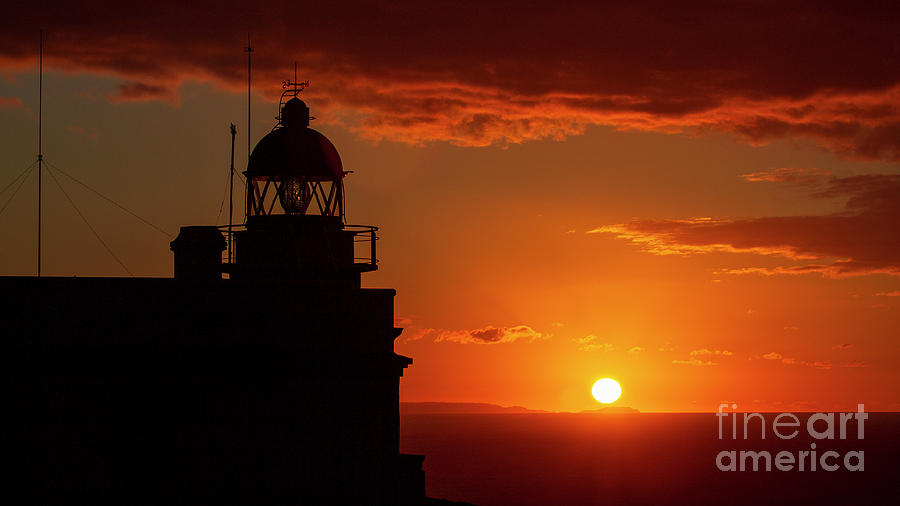 Cape Prior Silhouetted Lighthouse against Orange Sky Sunset and Sun at the Horizon Ferrol La Corua Galicia Photograph by Pablo Avanzini