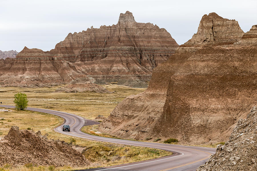 Car Driving along winding road, Badlands National Park, South Dakota, America, USA Photograph by Kathleencarney