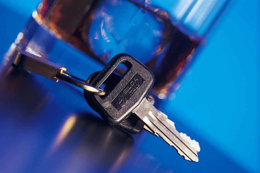 Car keys next to alcoholic beverage Photograph by Comstock