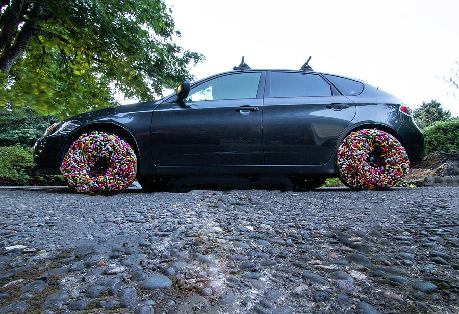 Car with donut wheels Photograph by Douglas Arnet