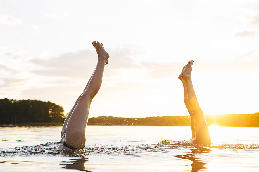 Carefree Summer Day: Two Teenage Girls Making Handstand In Lake Photograph by Fotografixx