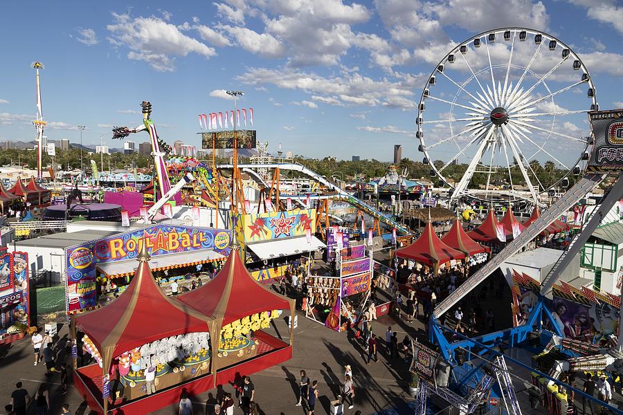 Carnival rides and games including a Ferris wheel in Phoenix at the