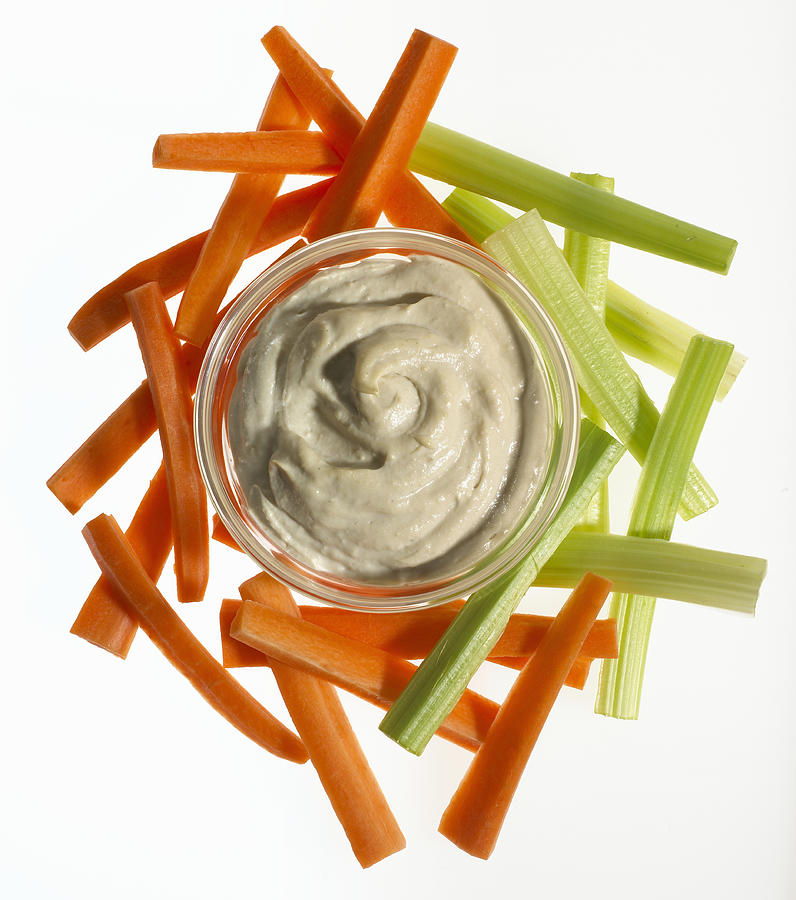 Carrot and celery sticks and bowl of hummus dip Photograph by Alex Cao