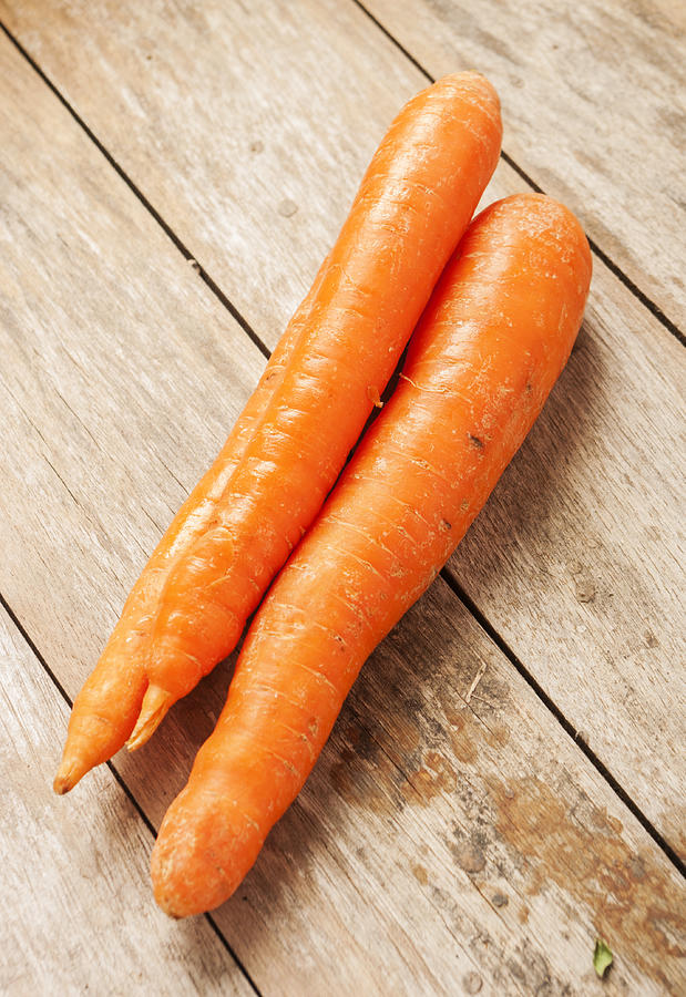 Carrot On Wooden Background Photograph by Funkybg