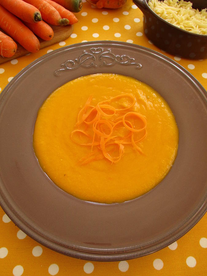 Carrot soup in brown plate Photograph by Tanai
