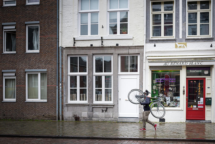 Carrying the bike Photograph by Tom Van den Bossche