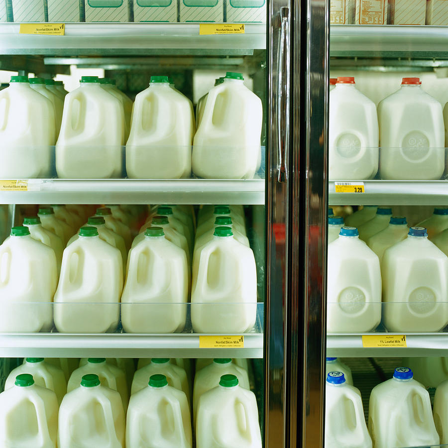 Cartons of milk in supermarket refrigerator, full frame Photograph by Chad Baker/Jason Reed/Ryan McVay
