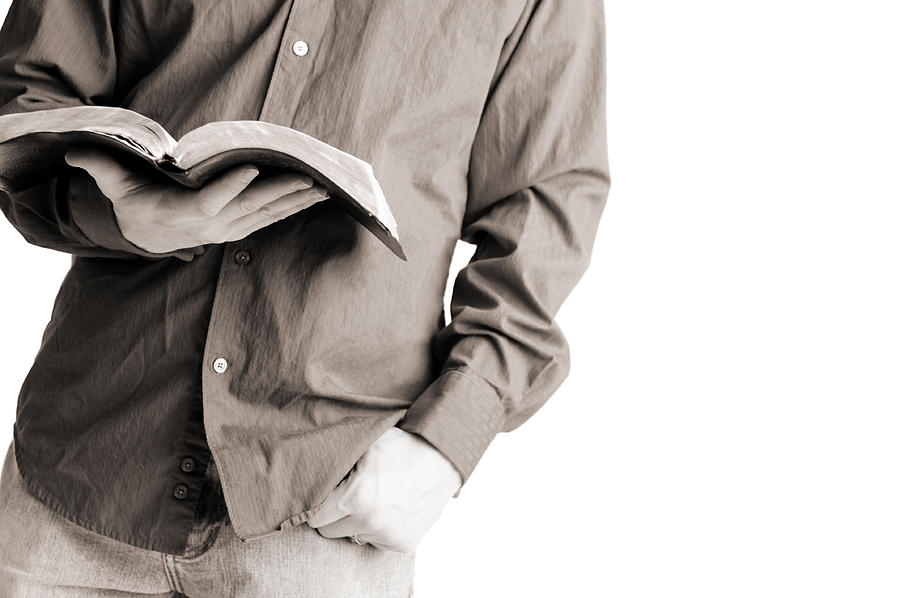 Casually Dressed Christian Man Holding Open Bible Photograph by Ideabug
