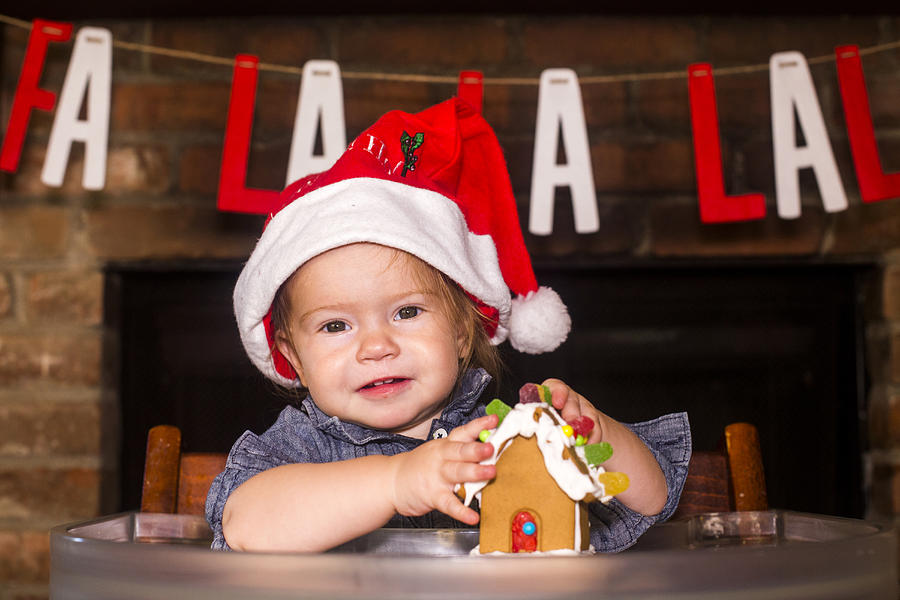Caucasian boy holding gingerbread house Photograph by Adam Hester