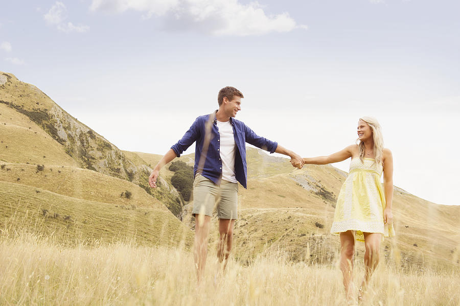 Caucasian couple holding hands in rural landscape Photograph by Jacobs Stock Photography Ltd