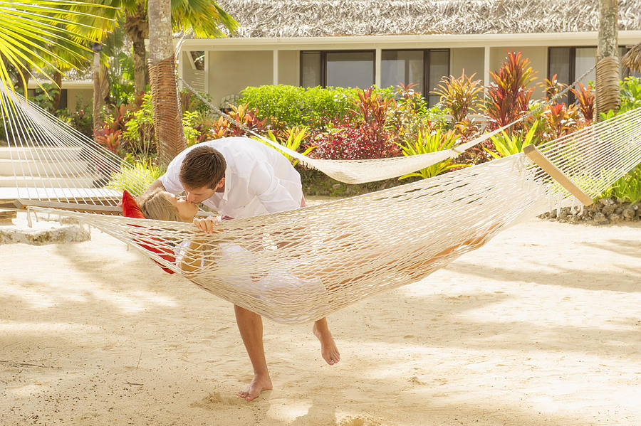 Caucasian couple kissing in hammock Photograph by Jacobs Stock Photography Ltd