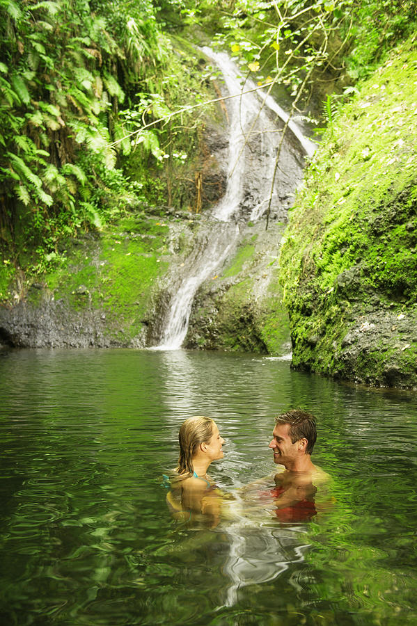 Caucasian couple swimming in remote jungle pool Photograph by Jacobs Stock Photography Ltd