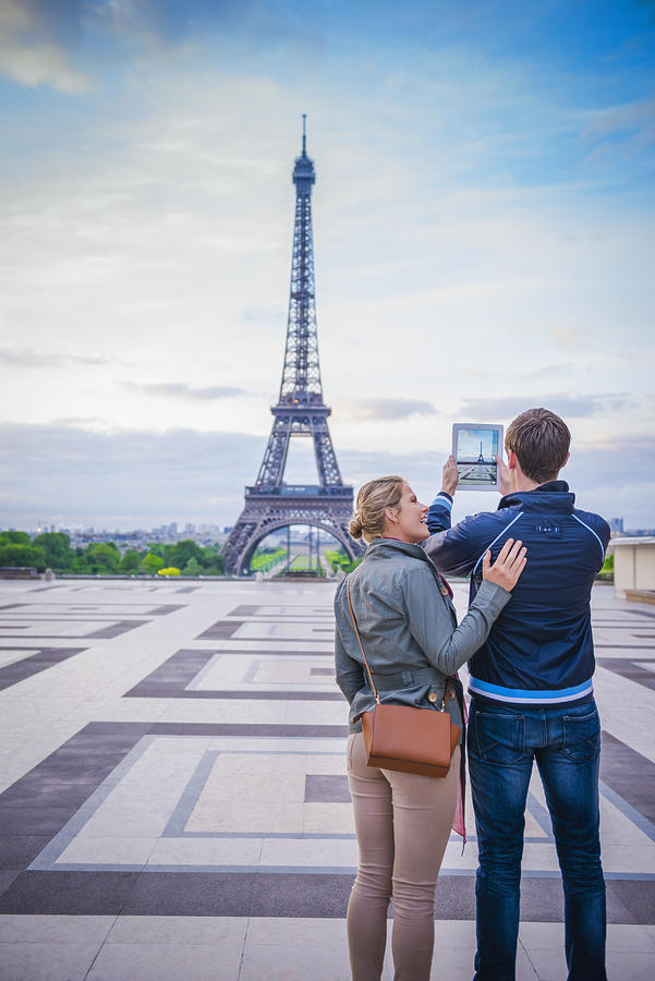 Caucasian couple taking photograph of Eiffel Tower, Paris, France Photograph by Jacobs Stock Photography Ltd