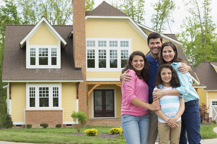 Caucasian family smiling outside house Photograph by Ariel Skelley Caucasian family smiling outside house Photograph by Ariel Skelley