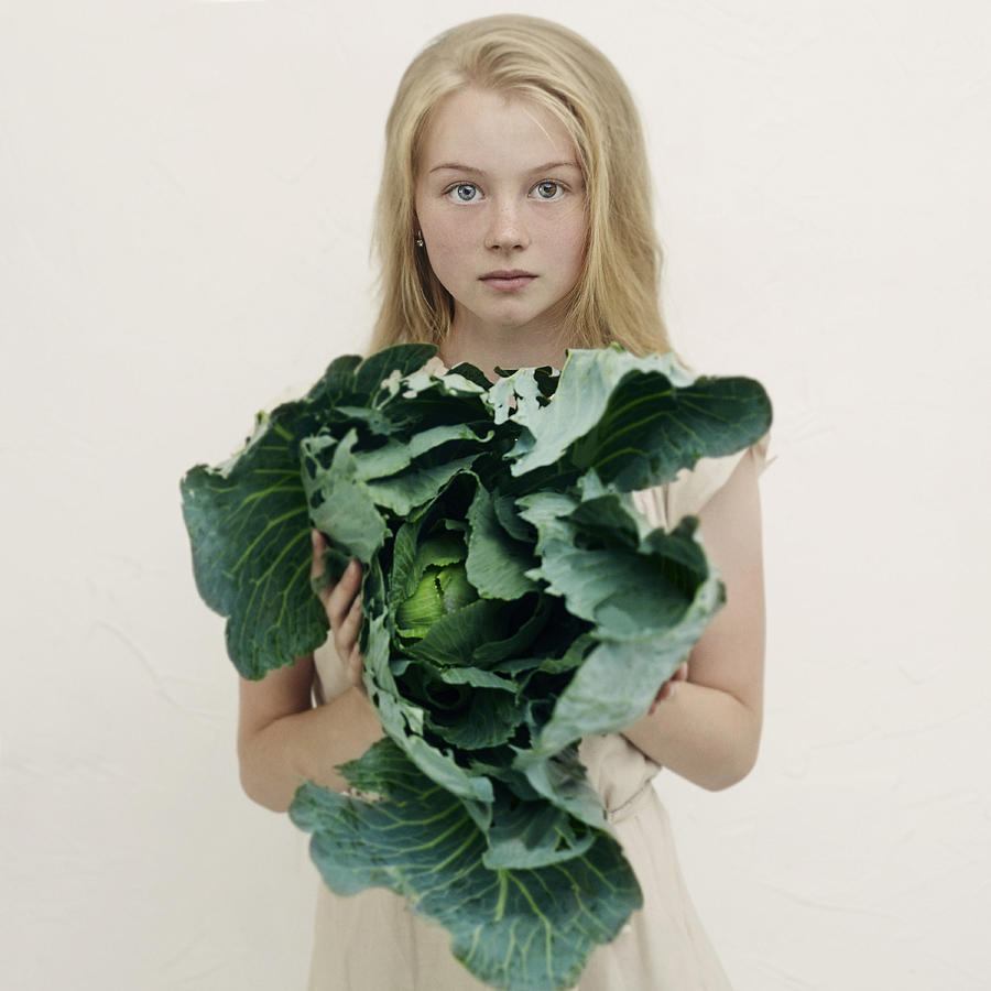Caucasian girl holding leafy green lettuce Photograph by Vladimir Serov