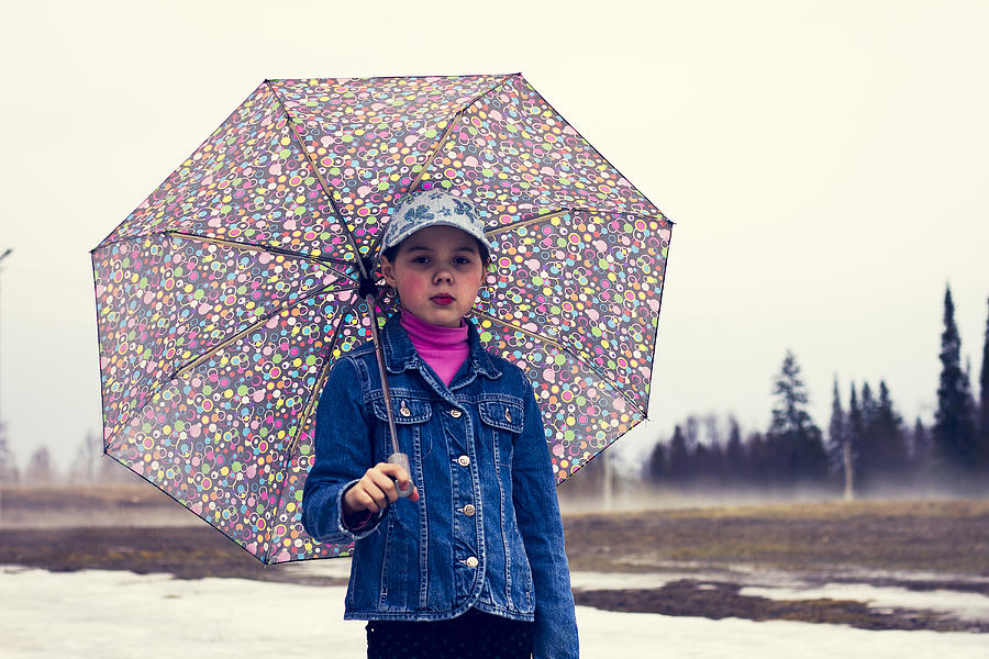 Caucasian girl walking under umbrella in snowy field Photograph by Maxim Chuvashov