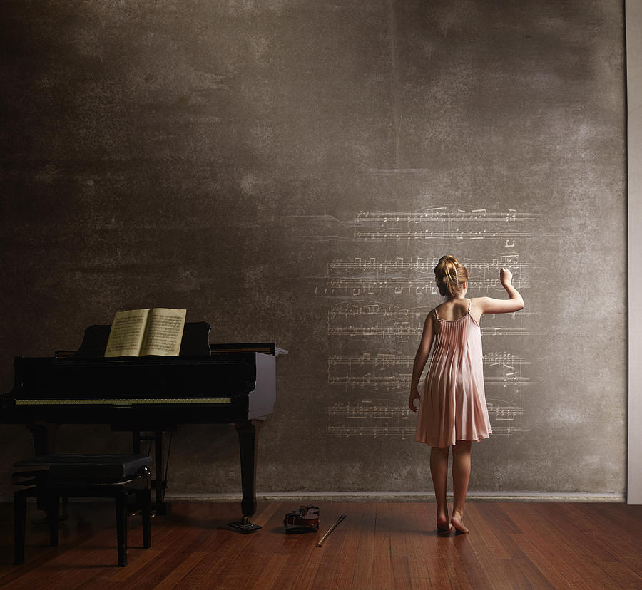 Caucasian girl writing music on blackboard Photograph by Colin Anderson Productions pty ltd