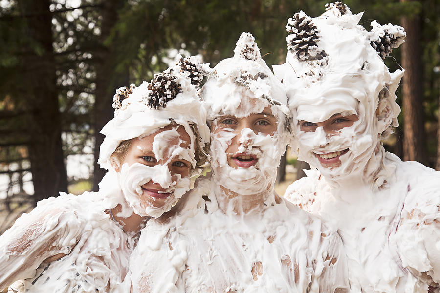 Caucasian girls covered with whipped cream and pine cones Photograph by Ronnie Kaufman