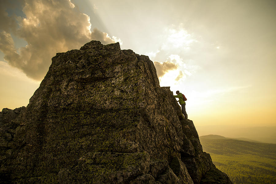 Caucasian hiker climbing on rock formation Photograph by Aleksander Rubtsov