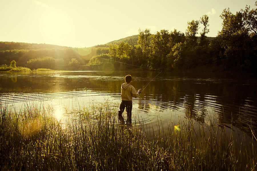 Caucasian man fishing in still lake Photograph by Aliyev Alexei Sergeevich