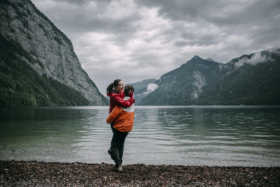 Caucasian man hugging near mountain lake Photograph by Alexey Karamanov