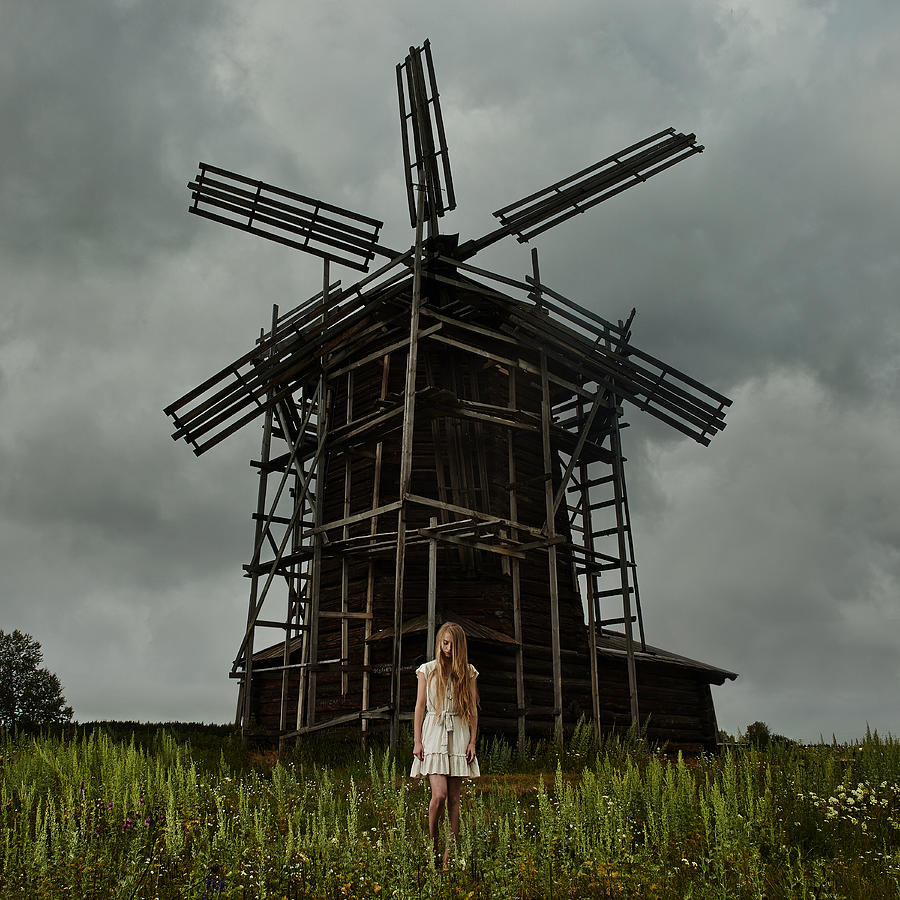 Caucasian teenage girl standing under wooden windmill Photograph by Vladimir Serov