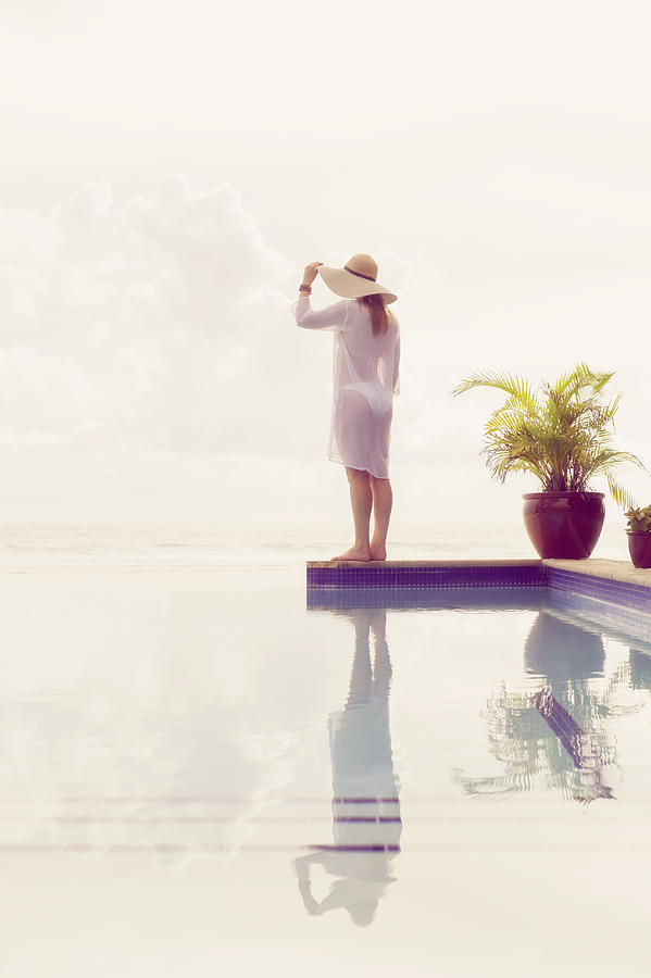 Caucasian woman admiring view from swimming pool Photograph by Jacobs Stock Photography Ltd