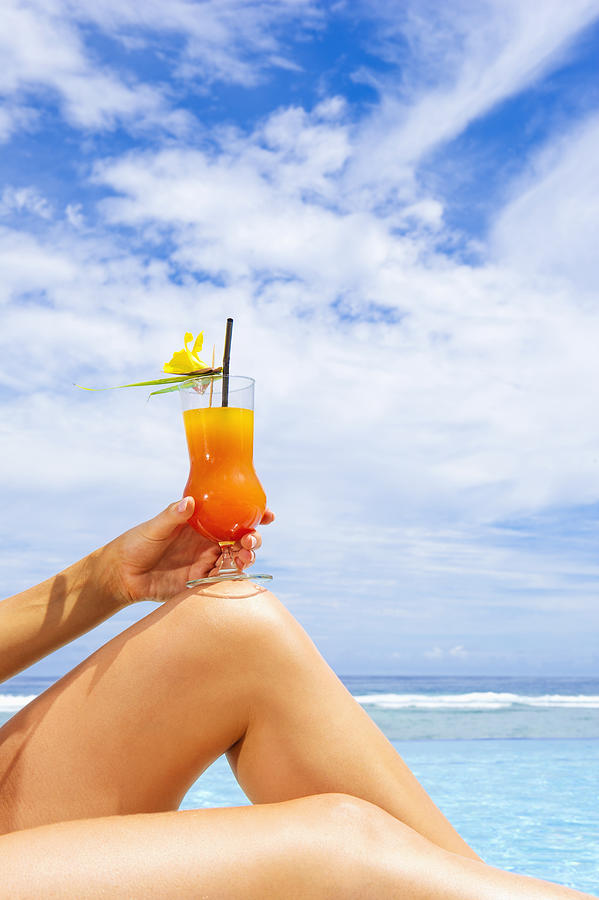 Caucasian woman drinking cocktail at beach Photograph by Jacobs Stock Photography Ltd