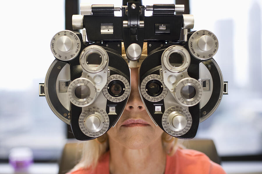 Caucasian woman having eye exam Photograph by ER Productions Limited