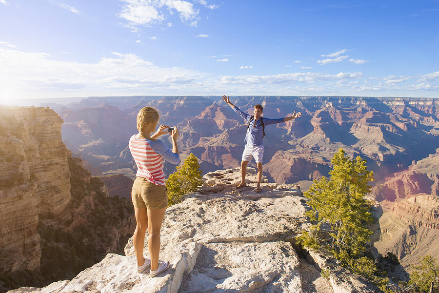 Caucasian woman photographing boyfriend in desert landscape, Grand Canyon, Arizona, United States Photograph by Jacobs Stock Photography Ltd