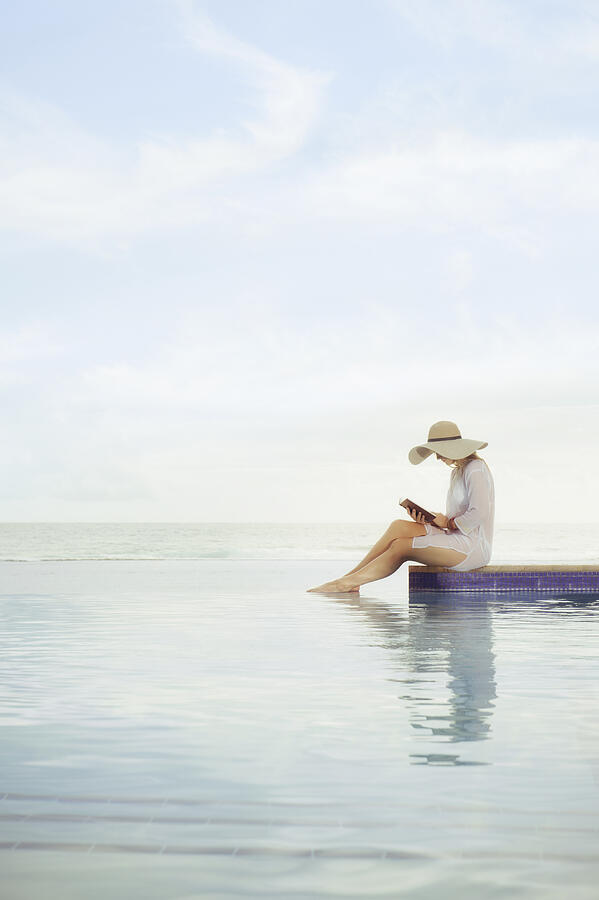 Caucasian woman relaxing at swimming pool Photograph by Jacobs Stock Photography Ltd