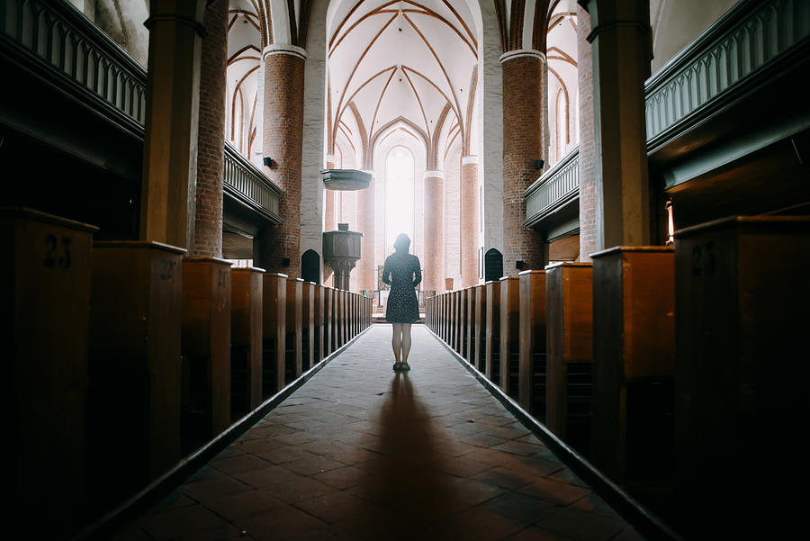 Caucasian woman standing in aisle of church Photograph by Alexey Karamanov