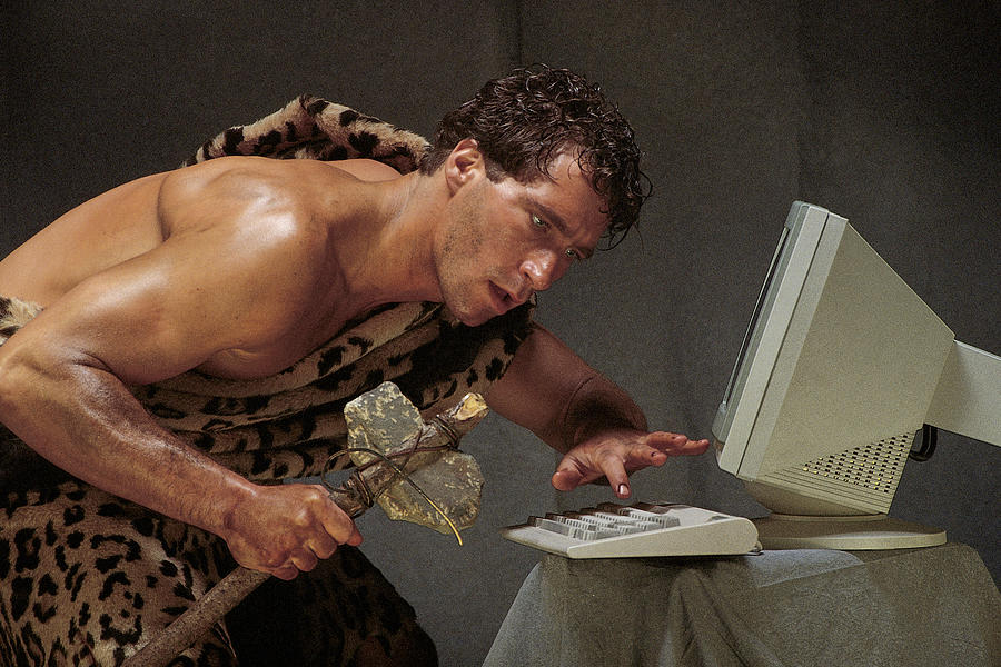 Caveman with computer Photograph by Comstock