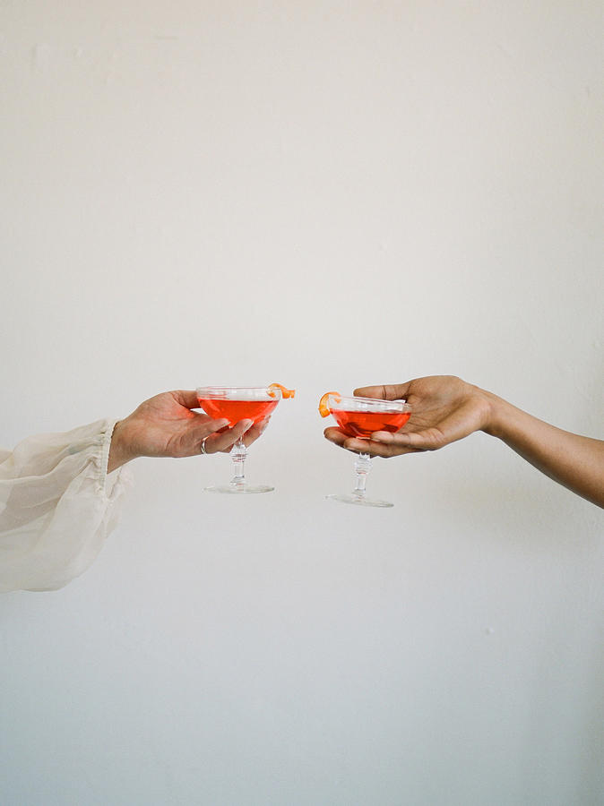 Celebratory Toast Close Up Of Hands Holding Pink Cocktails Shot On Film Photograph by Shaw Photography Co.