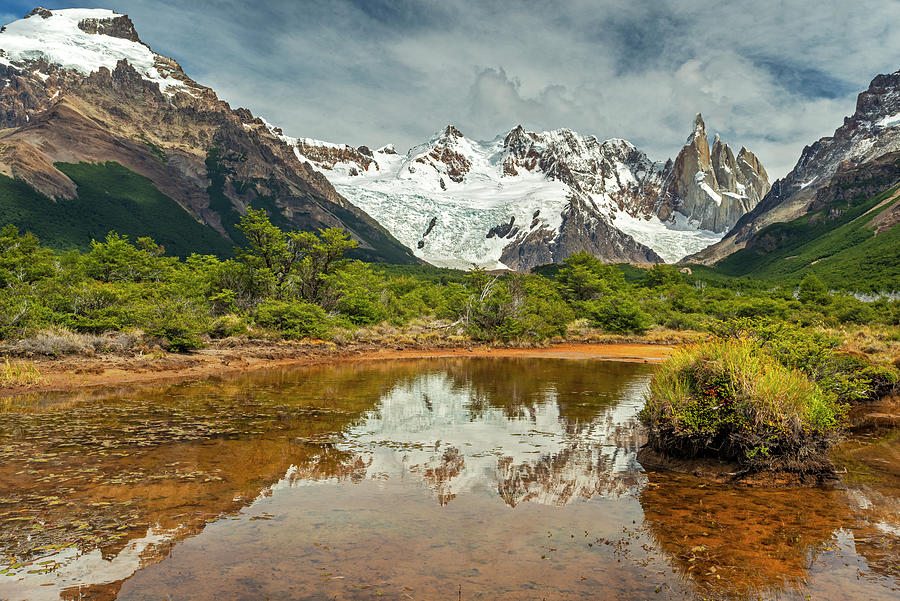 Cerro Torre reflecting in a pond Photograph by Henri Leduc