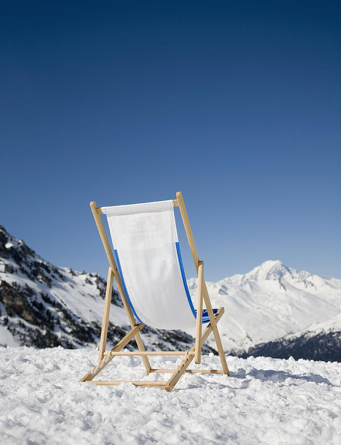Chair in snow with view of French Alps Photograph by Ashley Jouhar