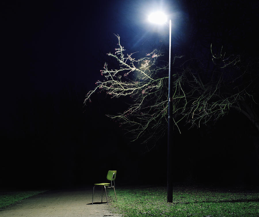 Chair under street light in park at night Photograph by Muriel de Seze