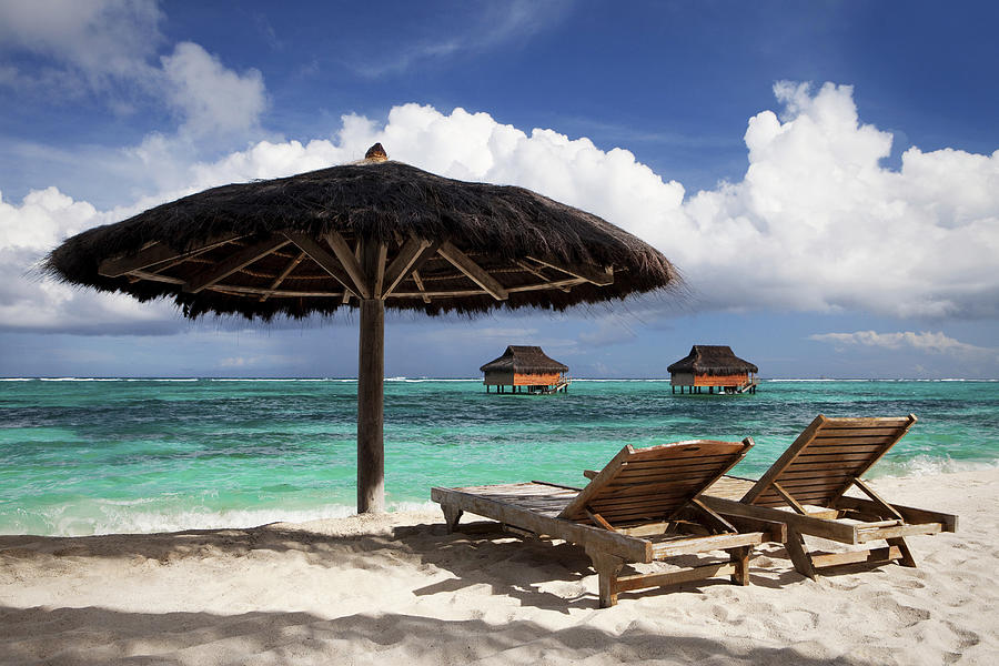 Chairs and umbrella on tropical beach Photograph by Image Source RF/Justin Lewis