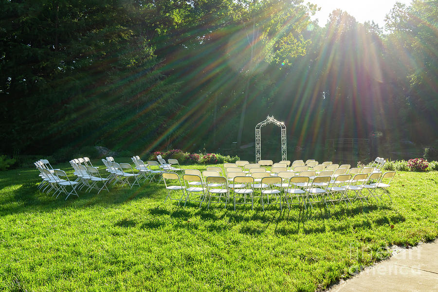 Chairs are set up for a wedding in morning light at Edith J. Car Photograph by William Kuta