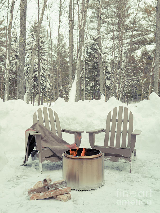 Chairs by a firepit in the snow Photograph by Edward Fielding