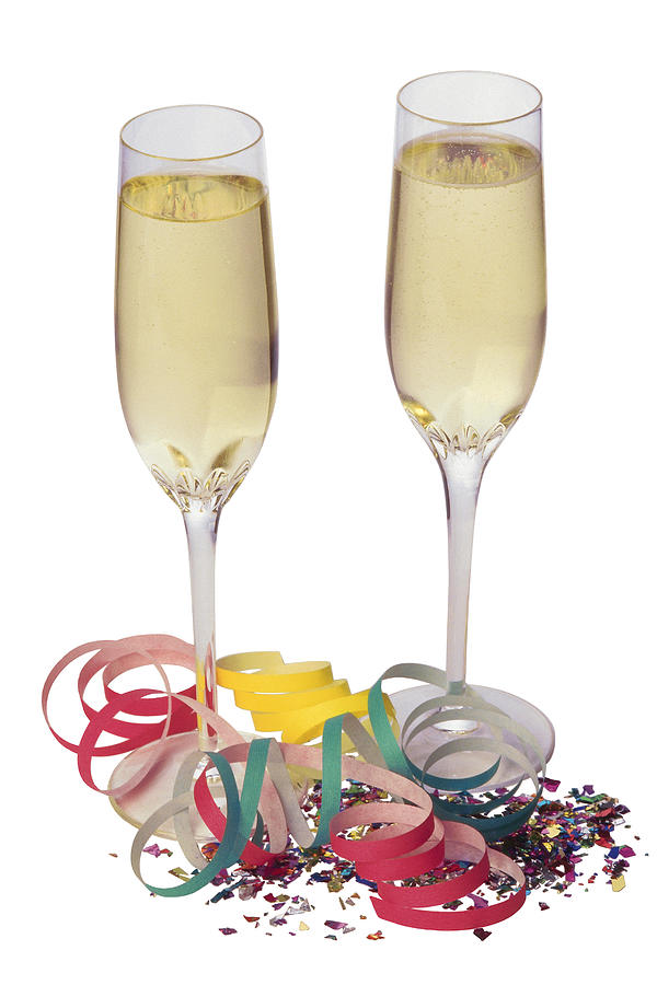 Champagne glasses with confetti and streamers Photograph by Comstock